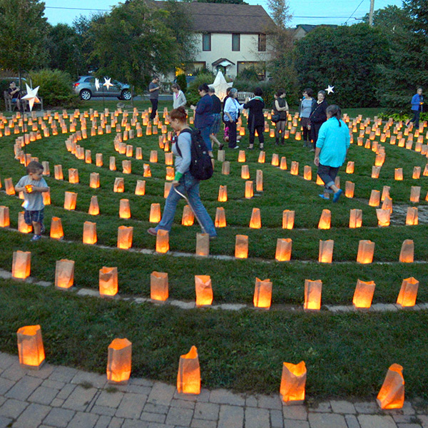 image of people walking through a lantern lit labyrinth