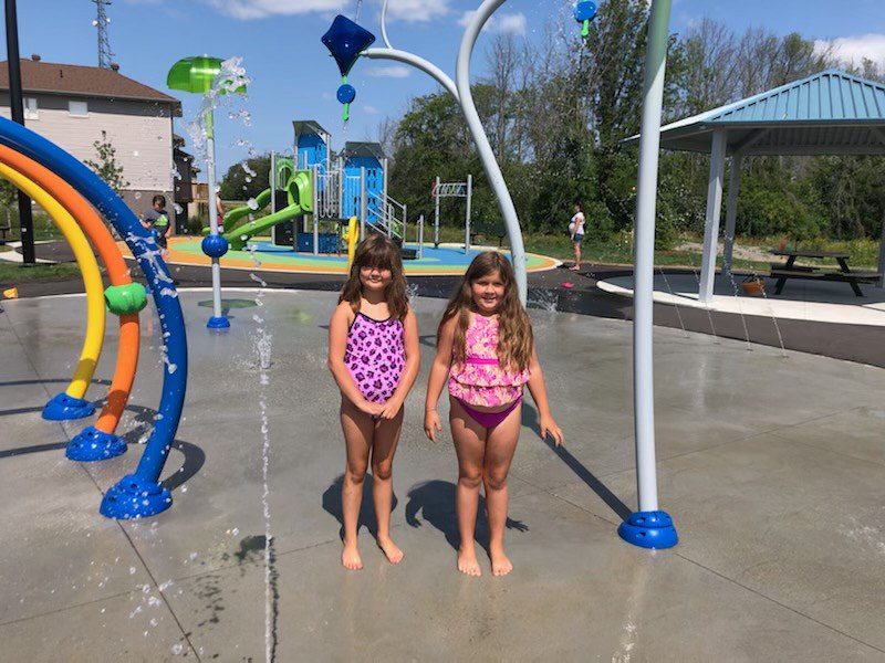 image of2 girls in bathing suits at a splash pad